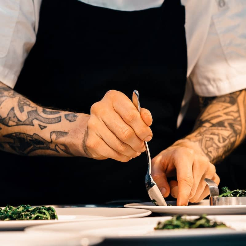 chef plating a meal carefully